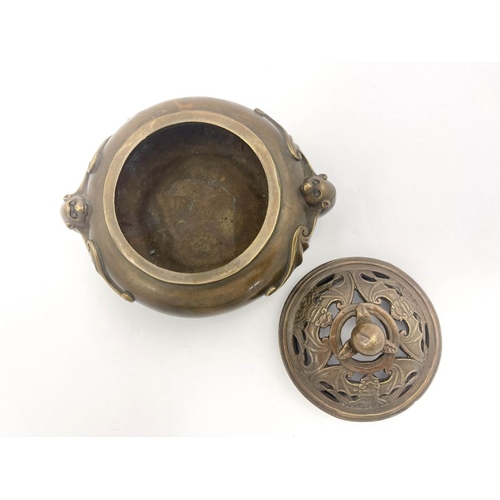 477 - A Chinese bronze censer, twin bat handles, the base bearing four character marks, pierced bronze cov... 