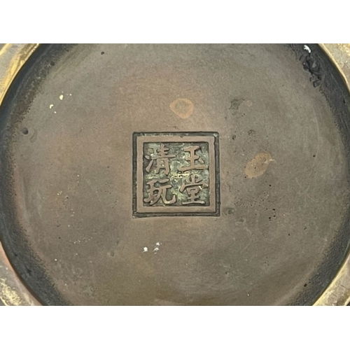 477 - A Chinese bronze censer, twin bat handles, the base bearing four character marks, pierced bronze cov... 