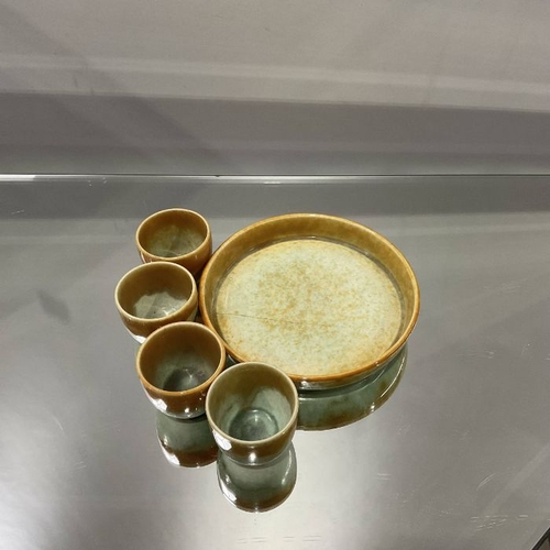 493 - A Ruskin egg stand, 1932, including four egg cups and a tray, orange over green glaze (5)