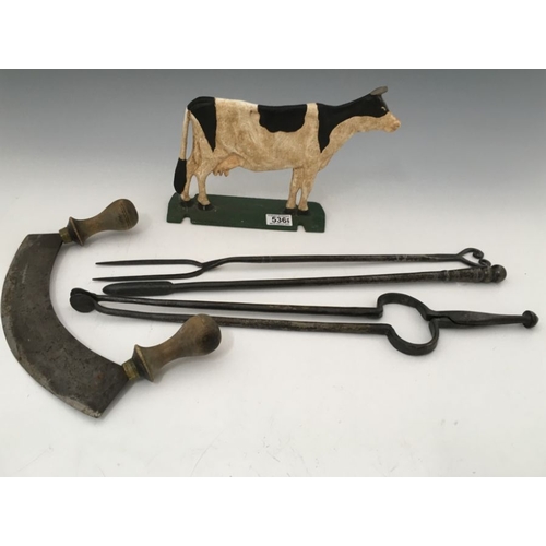 536 - Three wrought iron fire irons, a Mezzaluna with turned wooden handles, and a cast metal model of a c... 