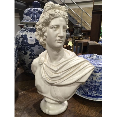 552 - A chalk ware bust portrait, modelled as Apollo Belvedere, 51cm high, together with a twin handled gl... 