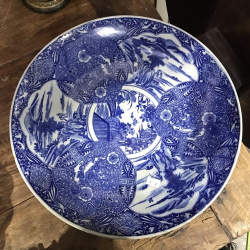 562 - An Oriental blue and white charger decorated with interlocking lotus cartouches, 45cm diameter