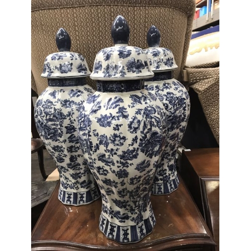 566 - Three blue and white altar table vases and covers in the Chinese style, lobed inverse baluster form,... 