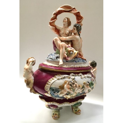 569 - A large Capodimonte relief moulded tureen and cover, modelled with figures, 42cm long