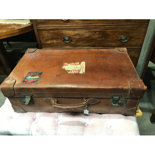 113 - John Pound & Co London, a vintage tan brown leather travel suitcase, studded leather corners and car... 