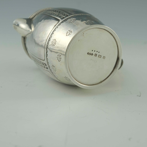 118 - Bernard Cuzner for Liberty and Co., an Arts and Crafts silver lidded jug, Birmingham 1919, barrel fo... 