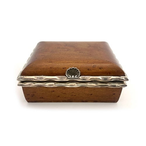 124 - An Arts and Crafts burr wood and white metal box, in the Omar Ramsden style, cushion topped cuboid f... 