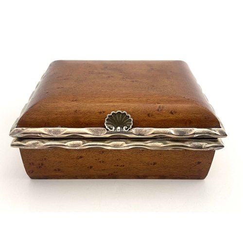 124 - An Arts and Crafts burr wood and white metal box, in the Omar Ramsden style, cushion topped cuboid f... 