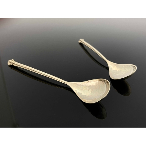 126 - Omar Ramsden, a pair of Arts and Crafts silver spoons, London 1925, planished, with cruciform sectio... 