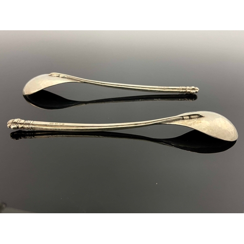 126 - Omar Ramsden, a pair of Arts and Crafts silver spoons, London 1925, planished, with cruciform sectio... 