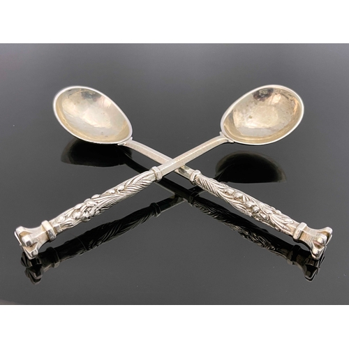 128 - Omar Ramsden, a pair of  Arts and Crafts silver spoons, London 1932, planished, hexagonal stems with... 