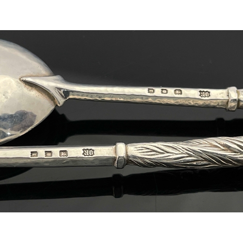 128 - Omar Ramsden, a pair of  Arts and Crafts silver spoons, London 1932, planished, hexagonal stems with... 