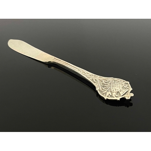 130 - Omar Ramsden, an Arts and Crafts silver butter knife, London 1930, planished, cast with a thistle ha... 