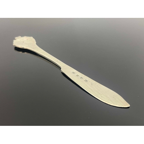 130 - Omar Ramsden, an Arts and Crafts silver butter knife, London 1930, planished, cast with a thistle ha... 