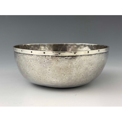 133 - An Arts and Crafts silver bowl, Adrian Harlaar, planished rounded form, applied with a rivet studded... 