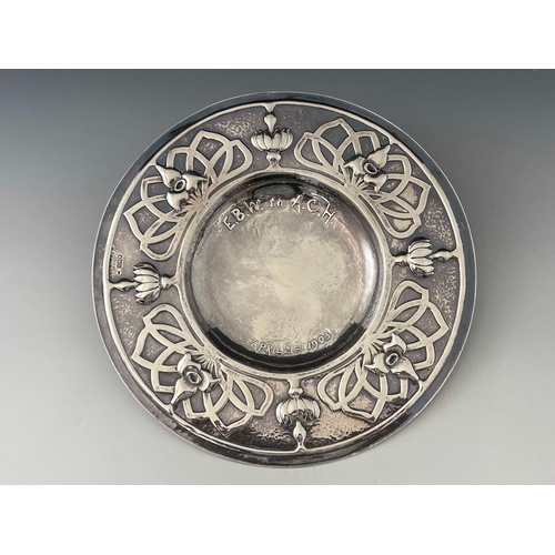 134 - An Arts and Crafts silver broad rimmed dish, William Joseph Byrne, London 1903, planished and repous... 