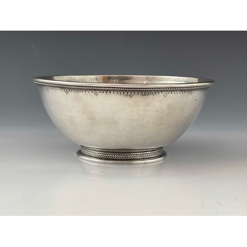 135 - An Arts and Crafts silver bowl, Charles Welch and Arthur Nevill Kirk, London 1919, planished and foo... 