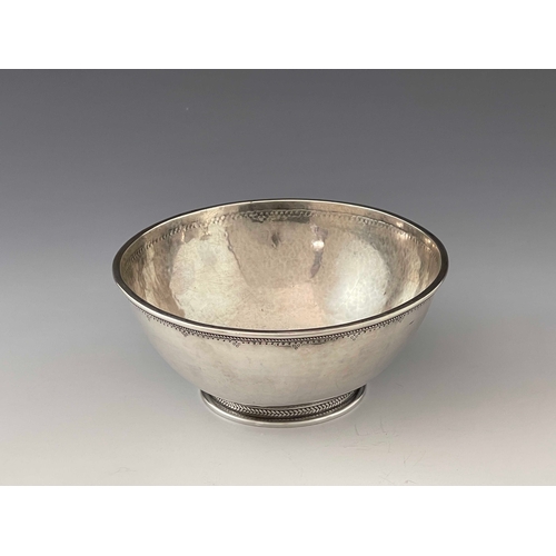 135 - An Arts and Crafts silver bowl, Charles Welch and Arthur Nevill Kirk, London 1919, planished and foo... 