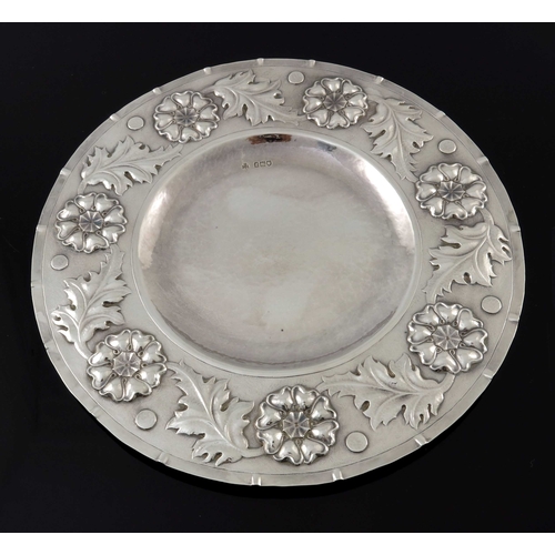 138 - An Arts and Crafts silver broad rimmed dish, William George Connell, London 1901, planished and repo... 