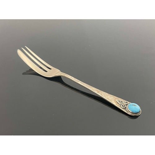 148 - Bernard Instone, an Arts and Crafts silver and turquoise cabochon set fork, Birmingham 1927, planish... 