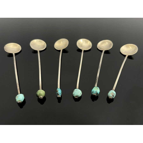 149 - A set of six Arts and Crafts turquoise and white metal coffee spoons, circa 1920, each with circular... 