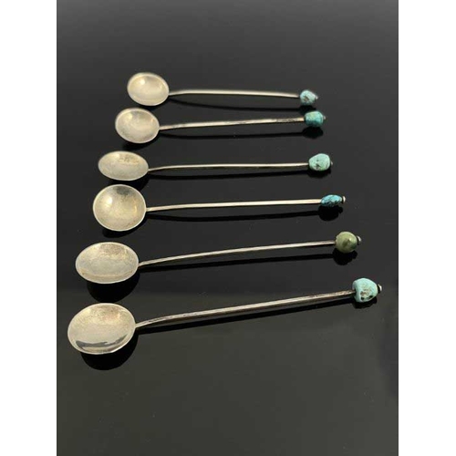 149 - A set of six Arts and Crafts turquoise and white metal coffee spoons, circa 1920, each with circular... 