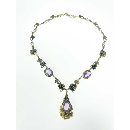 182 - An Arts and Crafts silver gilt and amethyst necklace, the central drop pendant with oval stone in ro... 