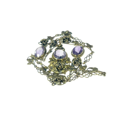 182 - An Arts and Crafts silver gilt and amethyst necklace, the central drop pendant with oval stone in ro... 