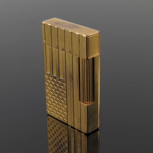 191 - S T Dupont, a gold plated American Flag lighter, relief moulded stars and stripes to each side, 6cm ... 