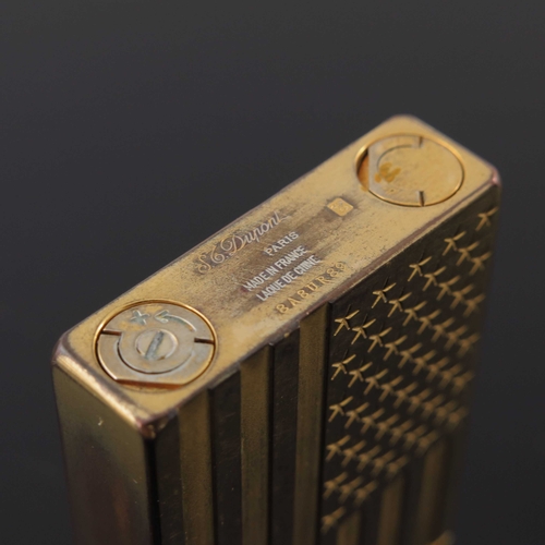 191 - S T Dupont, a gold plated American Flag lighter, relief moulded stars and stripes to each side, 6cm ... 