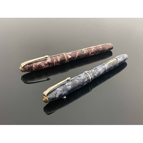 194 - Conway Stewart, two 75 fountain pens, blue and pink marbled, chromed fittings, lever filler, 14 cara... 