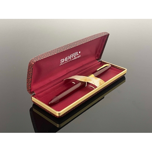 198 - Sheaffer, a Statesman Snorkel fountain pen, red burgundy with gold trim and 14 carat gold nib, in or... 