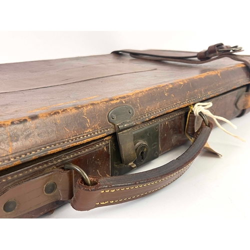 213 - A late 19th/early 20th century leather bound gun case, Bofs & Co London, the carcass covered in tool... 