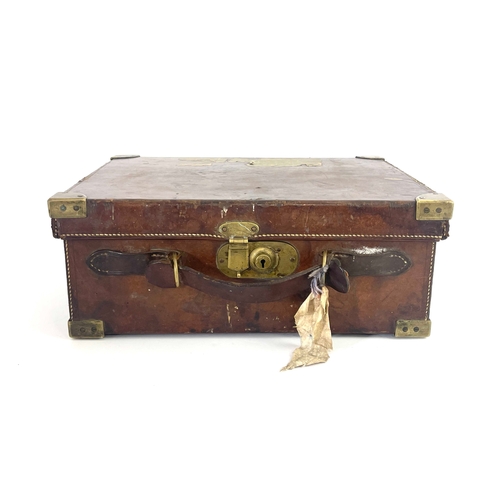 214 - A late 19th or early 20th century leather gun cartridge case, brass corner guards, secure lever lock... 