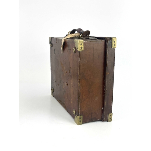 214 - A late 19th or early 20th century leather gun cartridge case, brass corner guards, secure lever lock... 