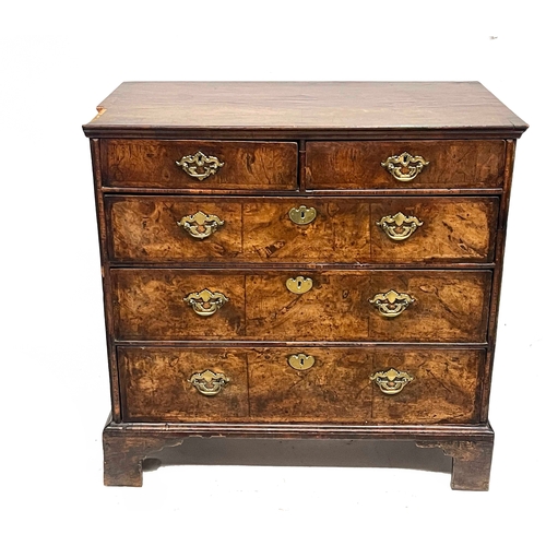 224 - A George I figured walnut and mahogany crossbanded chest of drawers, circa 1720 and later, moulded t... 