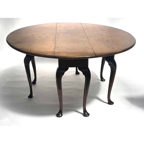 234 - Stuart Linford, a bespoke burr elm wake table, broad top with twin oval drop flaps, eight gateleg ac... 