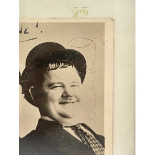 280 - Stan Laurel (1890-1965) and Oliver Hardy (1892-1957), a signed photograph of the duo, inscribed 'Hel... 