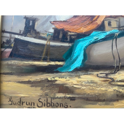 420 - Gudrun Sibbons (British, 1925), a coastal scene with a beached fishing boat and fishermen with their... 