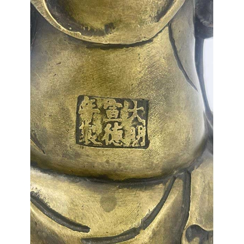 452 - A cast bronze figure of Guan Yin, modelled seated on a recumbent elephant, impressed seal mark, 28cm... 