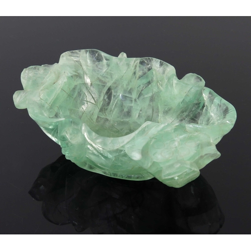 454 - A Chinese carved green quartz bowl, modelled as a leaf with lotus flowers, 14.5cm long