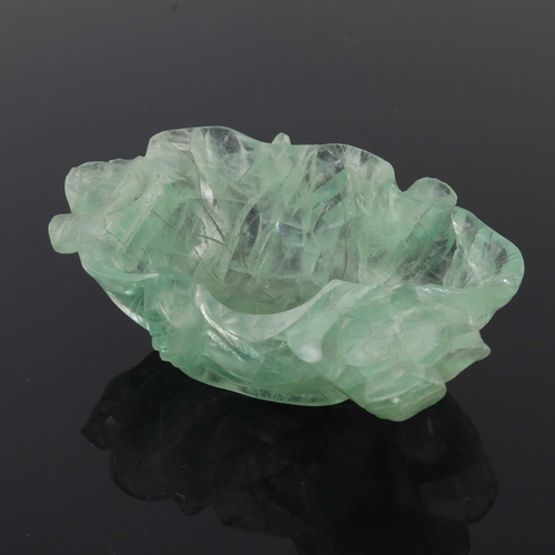 454 - A Chinese carved green quartz bowl, modelled as a leaf with lotus flowers, 14.5cm long