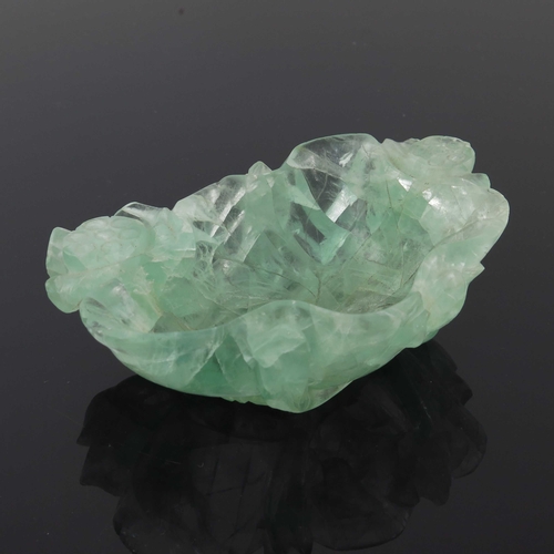 454 - A Chinese carved green quartz bowl, modelled as a leaf with lotus flowers, 14.5cm long