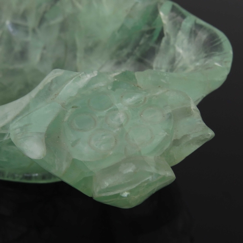 454 - A Chinese carved green quartz bowl, modelled as a leaf with lotus flowers, 14.5cm long