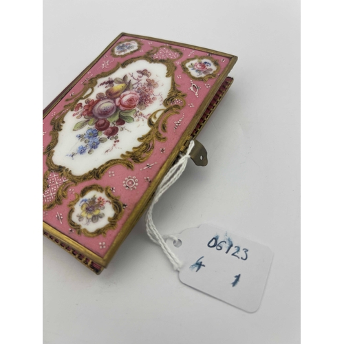 469 - A Limoges enamelled aide memoire, the cover panels painted with raised gilt Rococo scroll cartouches... 