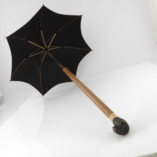 480 - A Victorian carved wood retractable parasol, Vickery, Regent Street, the pommel in the form of a par... 