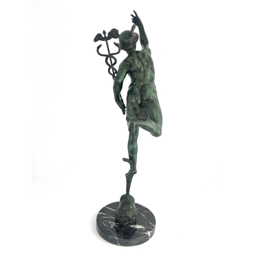 499 - After Giambologna, a green patinated bronzed figure of Mercury, mounted on a black veined circular m... 