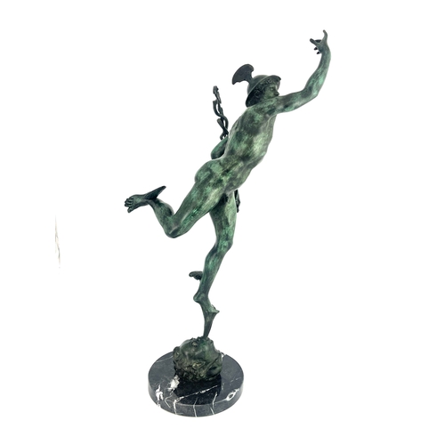 499 - After Giambologna, a green patinated bronzed figure of Mercury, mounted on a black veined circular m... 