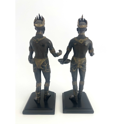 514 - A pair of bronze Nubian warrior figures, modelled wearing crowns and holding trays, highlighted in g... 