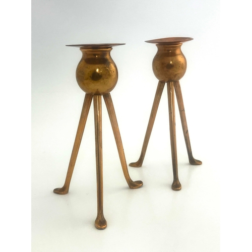 523A - Keswick School of Industrial Art, a pair of copper candlesticks, tripod bases, bud holders, sconces ... 